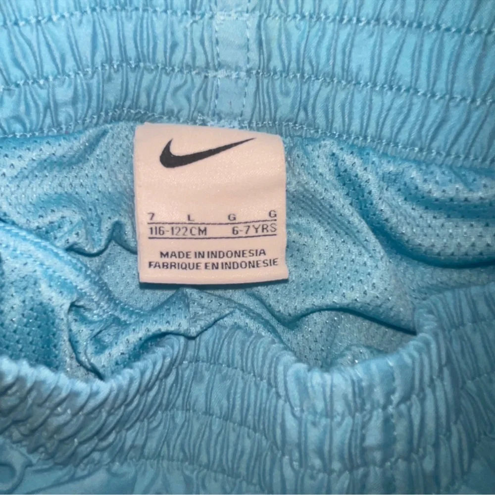 Nike boys swim trunks size 7 blue with black stripe